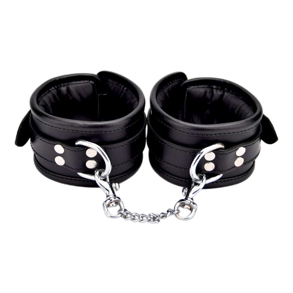 Bound Leather Wrist Restraints, Padded black leather wrist cuffs with silver trims joined by a short metal chain