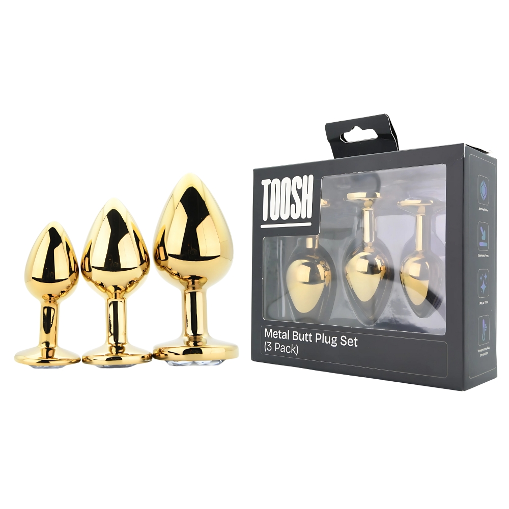 Toosh Metal Butt Plug Gold Set of 3 Clear Stone, Three gold metal butt plugs in graded sizes, each with a clear jewelled base