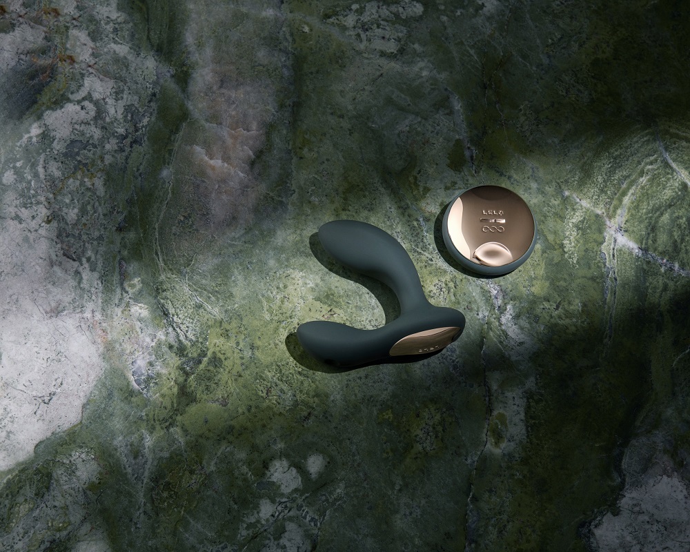 LELO Hugo 2 Remote Controlled Prostate Massager Black, Black curved prostate massager with a flared base, shown with a match…